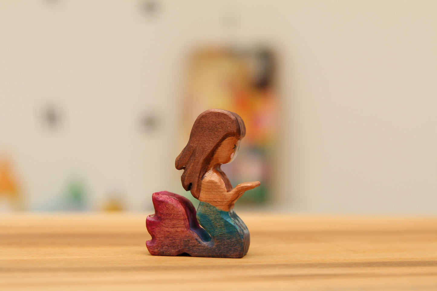 Kneeling mermaid with blue/pink tail