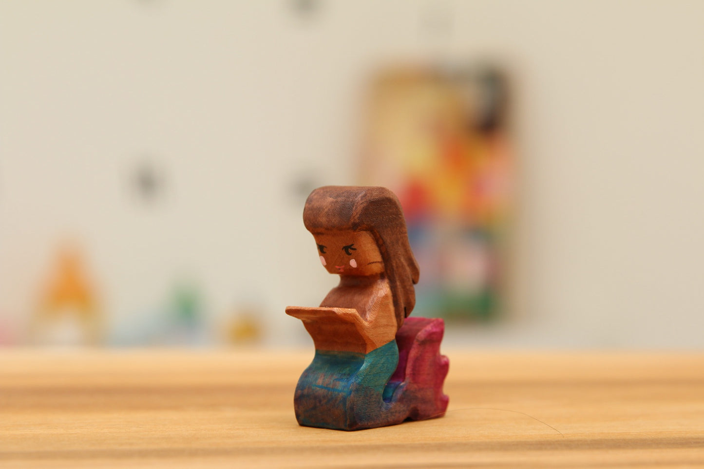 Kneeling mermaid with blue/pink tail
