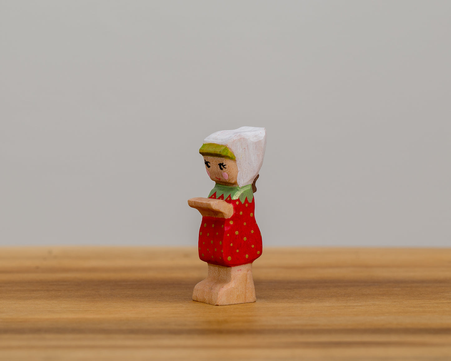 Short Strawberry Child with stationary arms and little ponytail