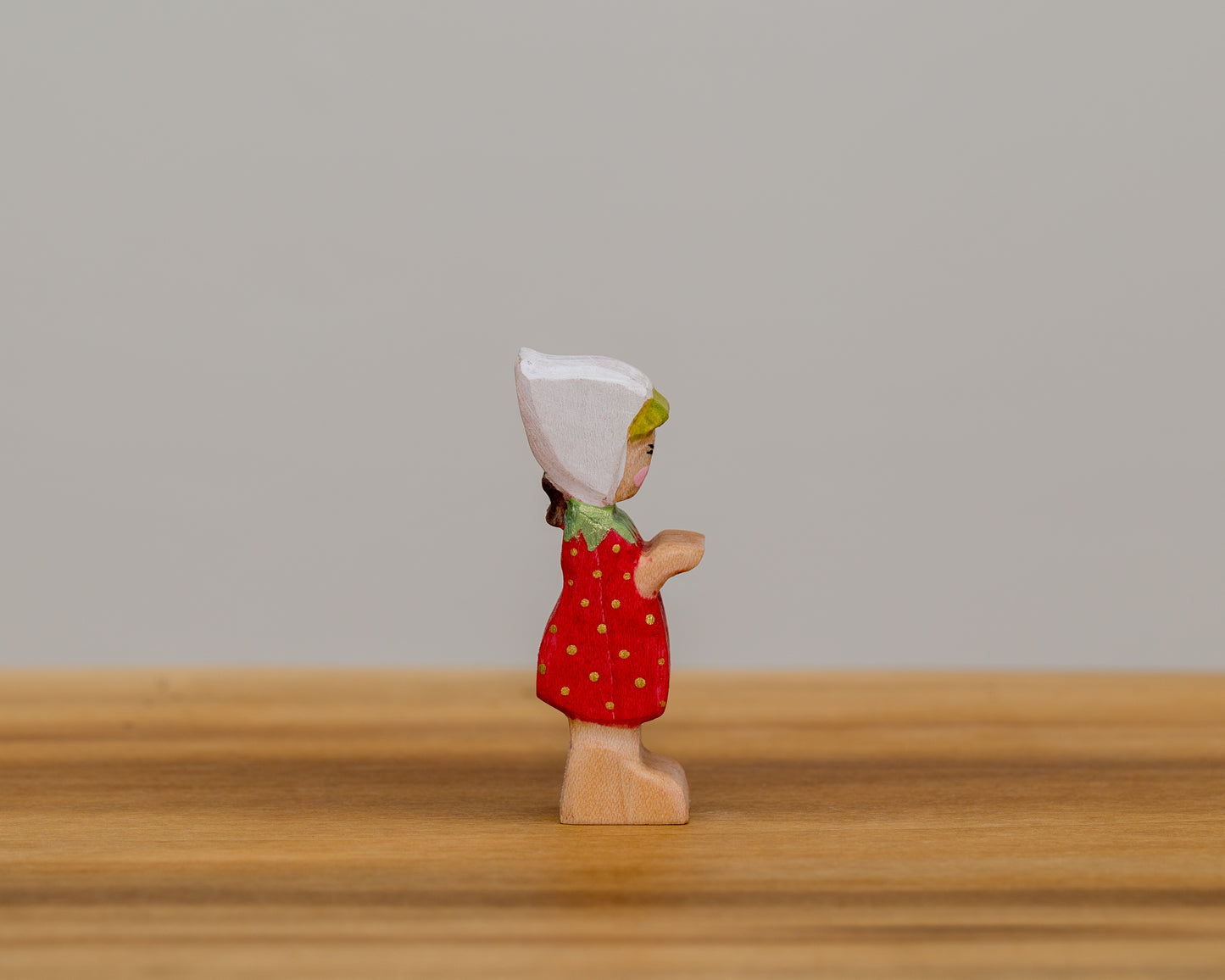 Short Strawberry Child with stationary arms and little ponytail