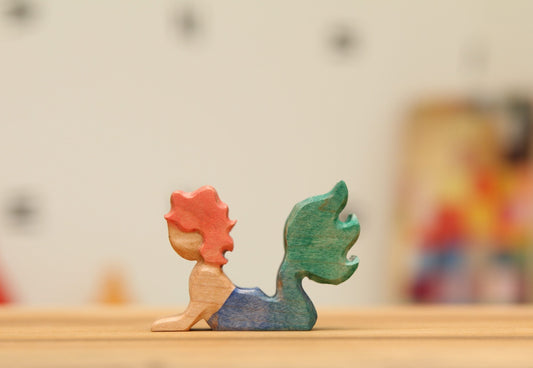 Swimming Mermaid in Maple with strawberry blond hair and blue/green tail