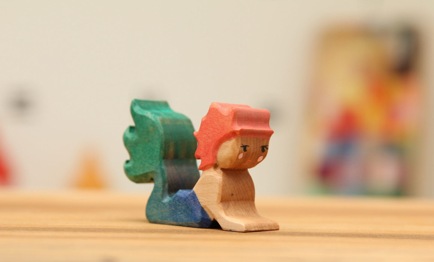 Swimming Mermaid in Maple with strawberry blond hair and blue/green tail