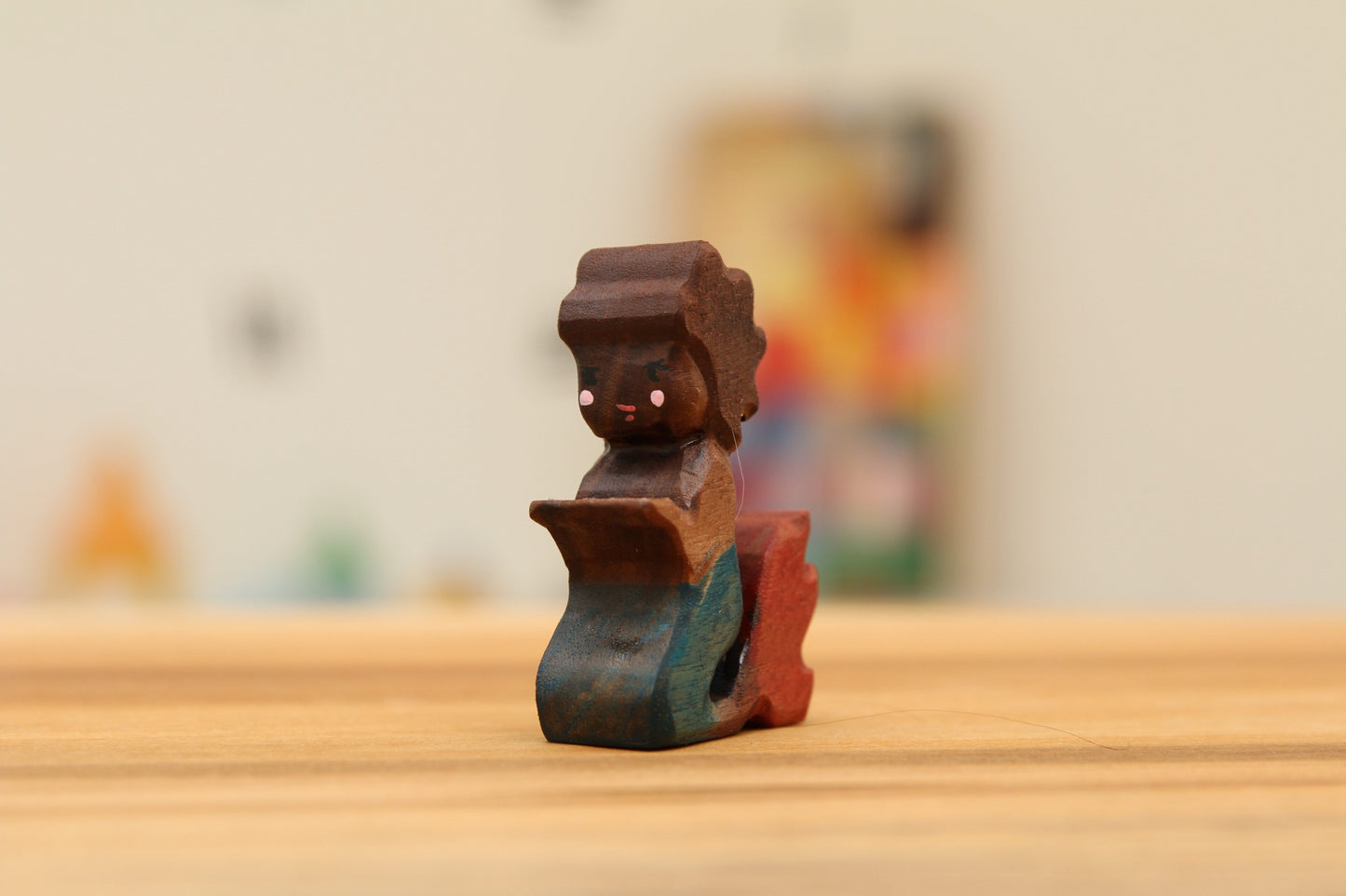 Walnut kneeling mermaid with brown hair and blue/red tail