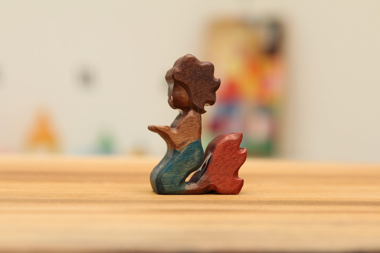 Walnut kneeling mermaid with brown hair and blue/red tail