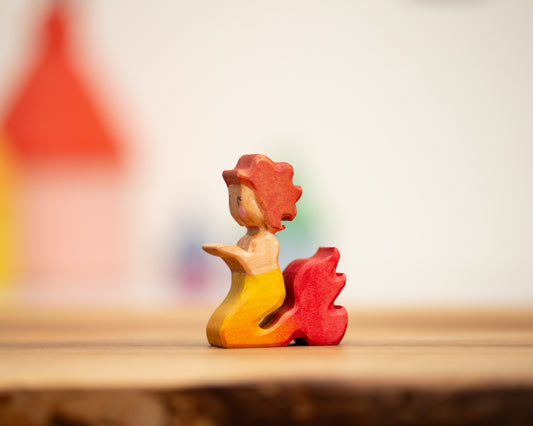 Kneeling yellow/red mermaid with auburn hair