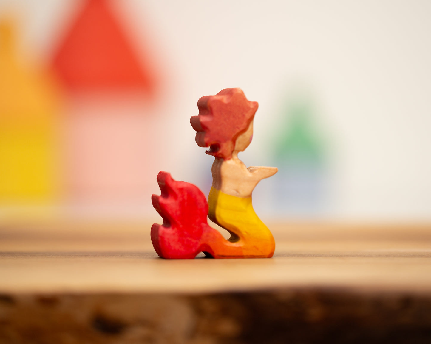 Kneeling yellow/red mermaid with auburn hair