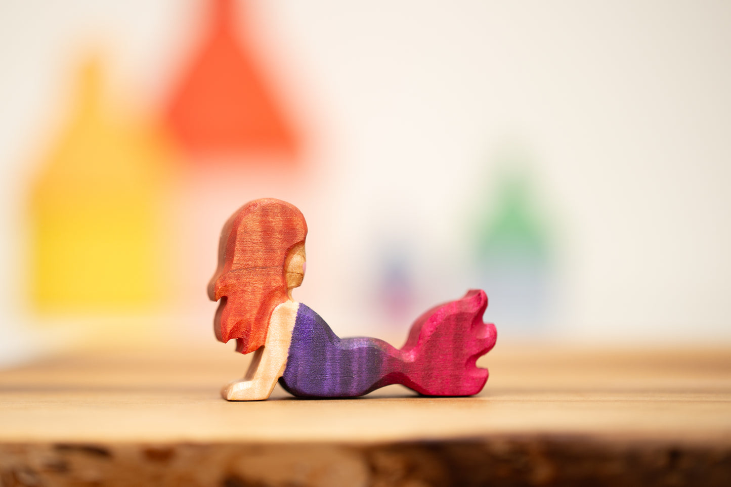 Reclining pink/purple mermaid with auburn hair