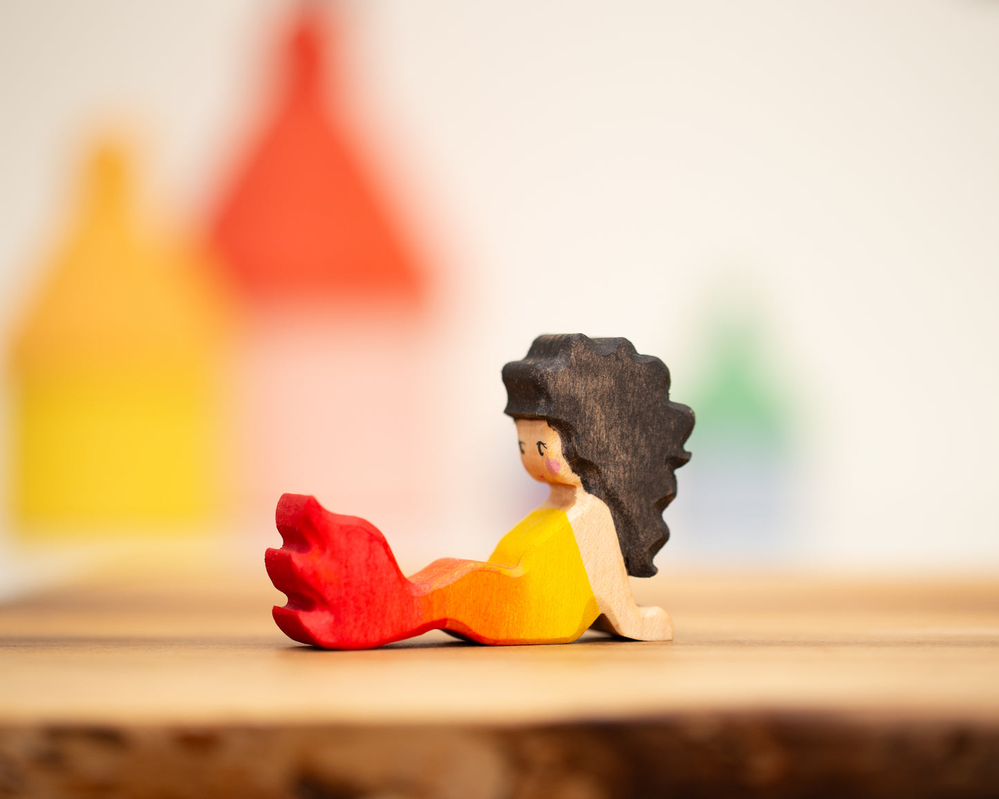 Reclining red/yellow mermaid with long black hair